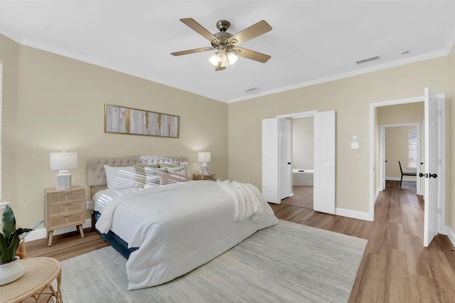 bedroom with crown molding, visible vents, ceiling fan, wood finished floors, and baseboards