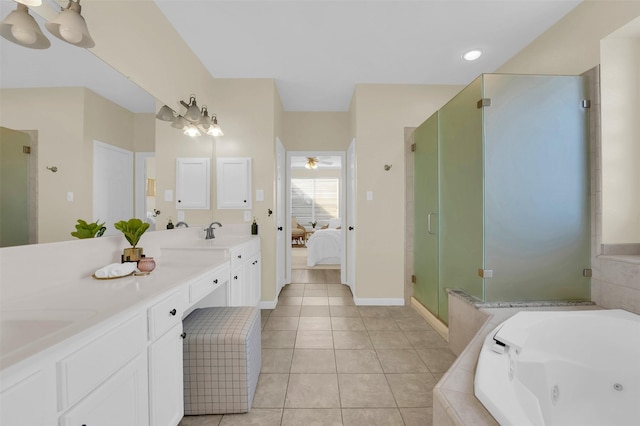 bathroom featuring double vanity, a stall shower, a tub with jets, ensuite bathroom, and tile patterned floors