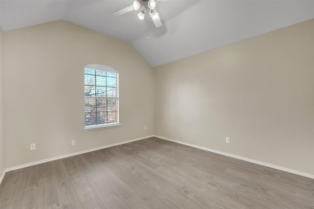 unfurnished room with vaulted ceiling, ceiling fan, light wood-type flooring, and baseboards