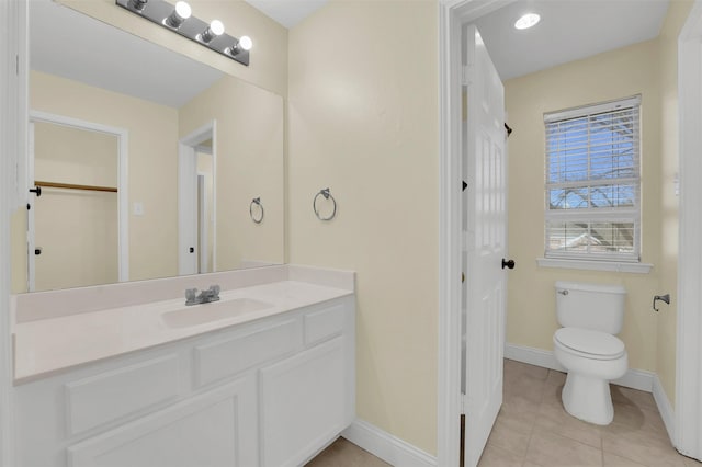 bathroom with tile patterned floors, vanity, toilet, and baseboards