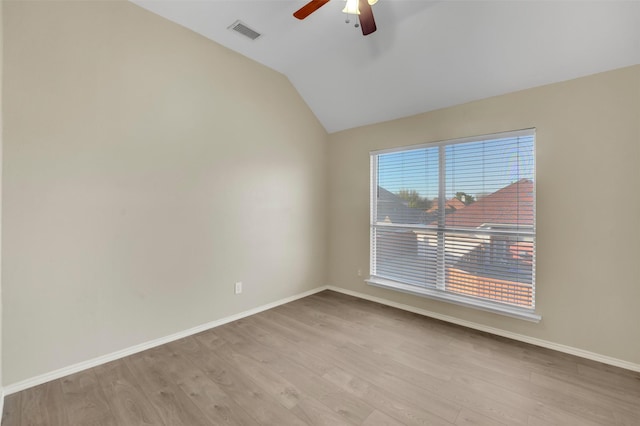 unfurnished room with lofted ceiling, baseboards, visible vents, and light wood finished floors