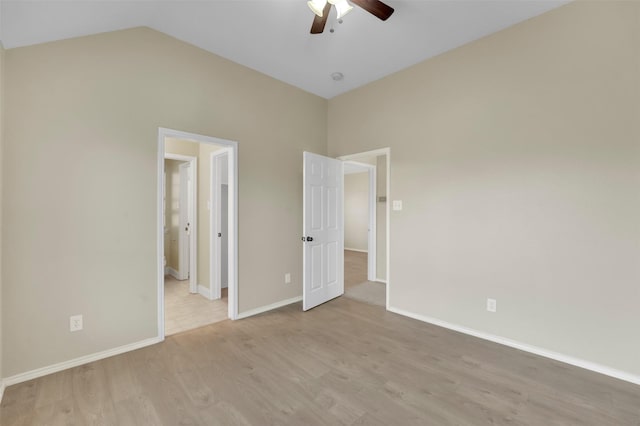 unfurnished bedroom featuring vaulted ceiling, ceiling fan, light wood-style flooring, and baseboards