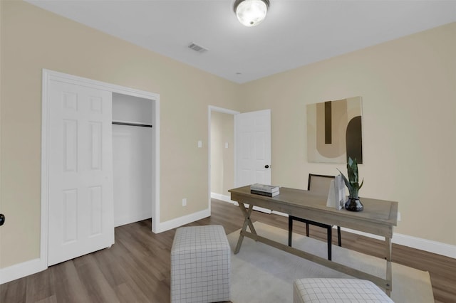 office with visible vents, baseboards, and wood finished floors