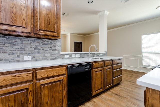 kitchen with black dishwasher, light countertops, a sink, and brown cabinets