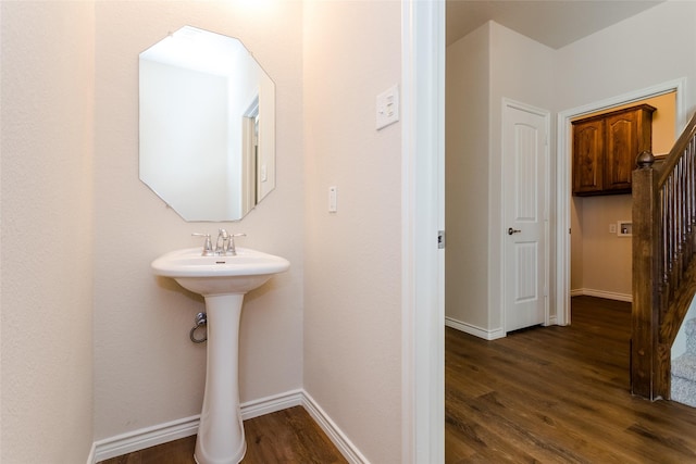 bathroom with baseboards and wood finished floors