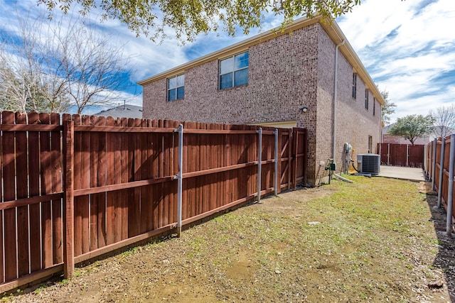 exterior space with a fenced backyard and central air condition unit