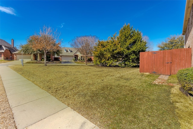 view of yard with fence and an attached garage