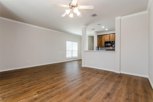 unfurnished living room featuring dark wood-style floors, ceiling fan, visible vents, and crown molding