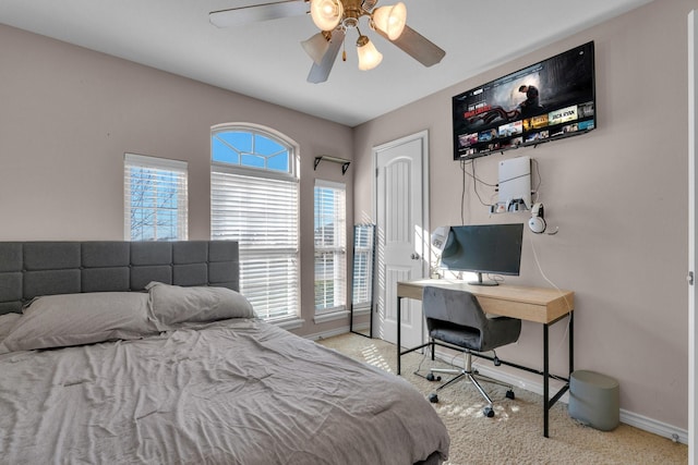 bedroom featuring ceiling fan, baseboards, and light colored carpet