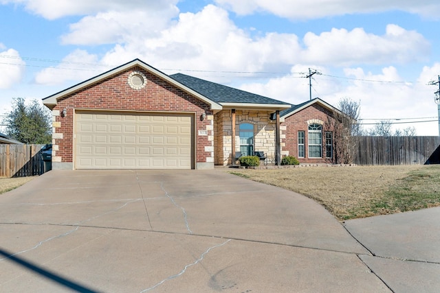 ranch-style house featuring brick siding, roof with shingles, concrete driveway, an attached garage, and fence