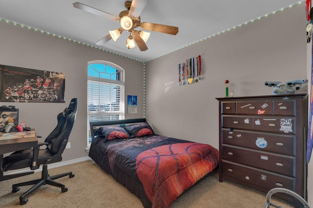 bedroom with light carpet, ceiling fan, and baseboards