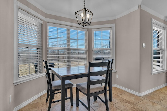 dining area featuring baseboards, a chandelier, and ornamental molding