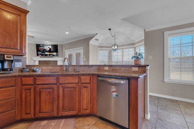 kitchen with a sink, crown molding, dark stone counters, and dishwasher