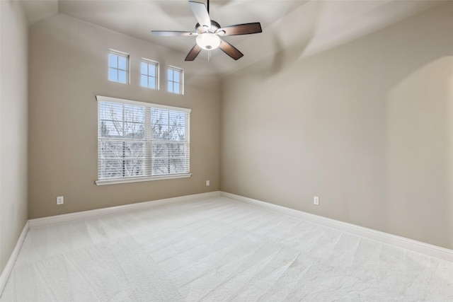 empty room featuring light carpet, ceiling fan, and baseboards