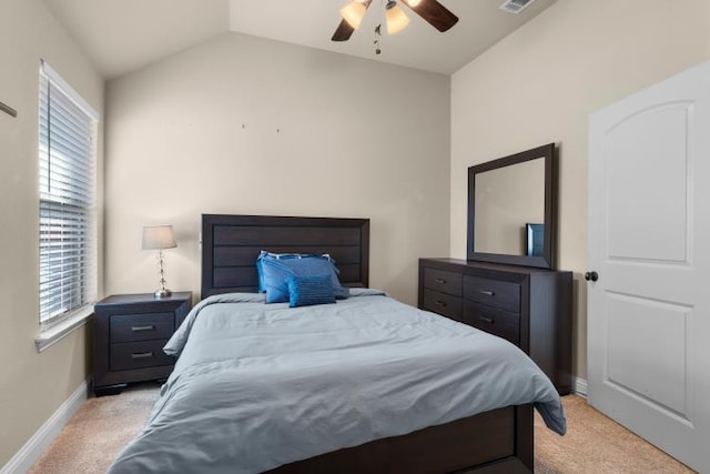 bedroom with light colored carpet, visible vents, a ceiling fan, vaulted ceiling, and baseboards