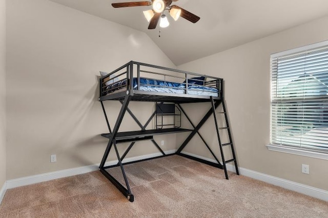 bedroom with carpet floors, baseboards, and lofted ceiling