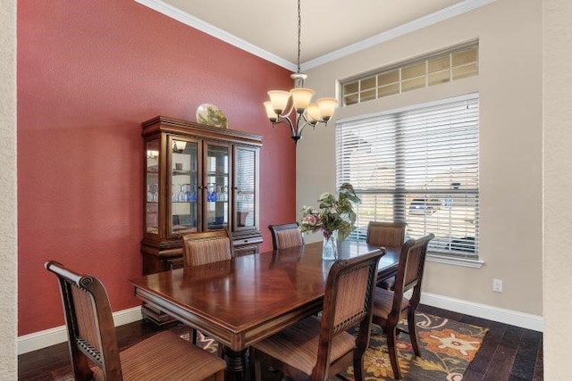 dining space with ornamental molding, a chandelier, dark wood-type flooring, and baseboards