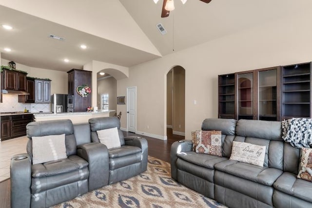 living area with arched walkways, recessed lighting, visible vents, and a ceiling fan