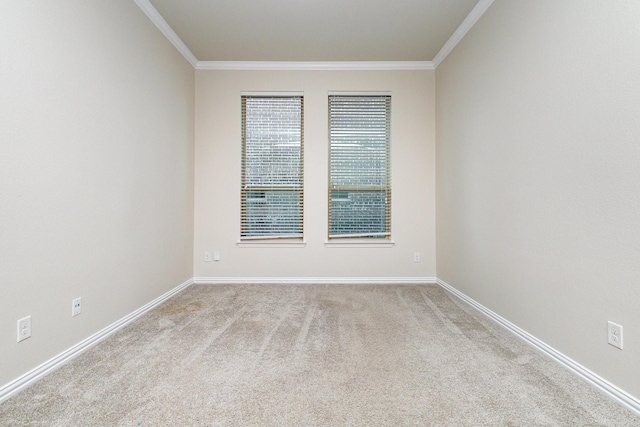 unfurnished room with baseboards, crown molding, and light colored carpet