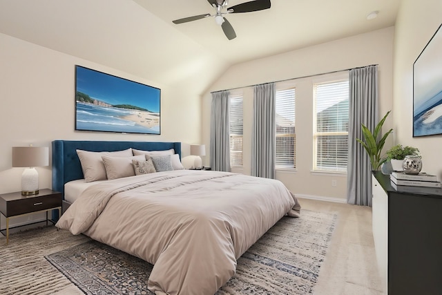 bedroom featuring lofted ceiling, ceiling fan, light colored carpet, and baseboards