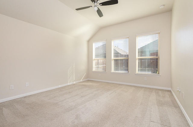 unfurnished room featuring light carpet, ceiling fan, lofted ceiling, and baseboards