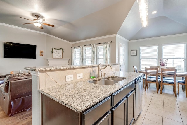 kitchen with crown molding, lofted ceiling, open floor plan, a sink, and dishwasher