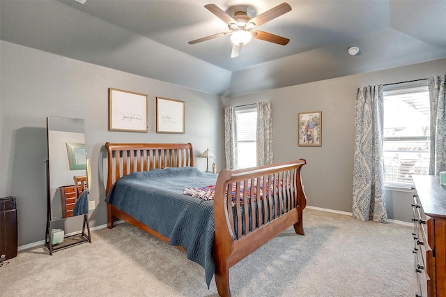 bedroom featuring vaulted ceiling, baseboards, a ceiling fan, and light colored carpet