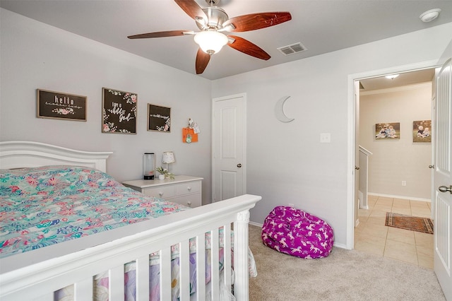 bedroom with light tile patterned floors, ceiling fan, light colored carpet, visible vents, and baseboards