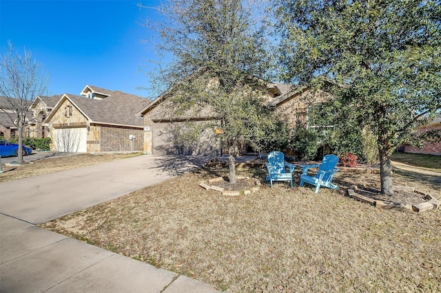 view of front of house with concrete driveway, brick siding, and an attached garage