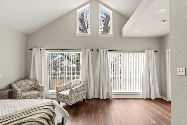 bedroom featuring lofted ceiling, multiple windows, wood finished floors, and visible vents