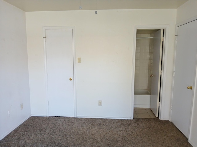 unfurnished bedroom featuring carpet and ensuite bathroom