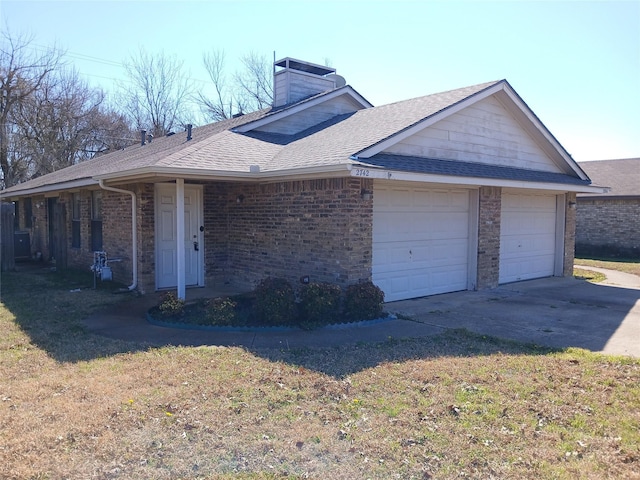 view of front facade featuring a garage, a shingled roof, brick siding, driveway, and a chimney