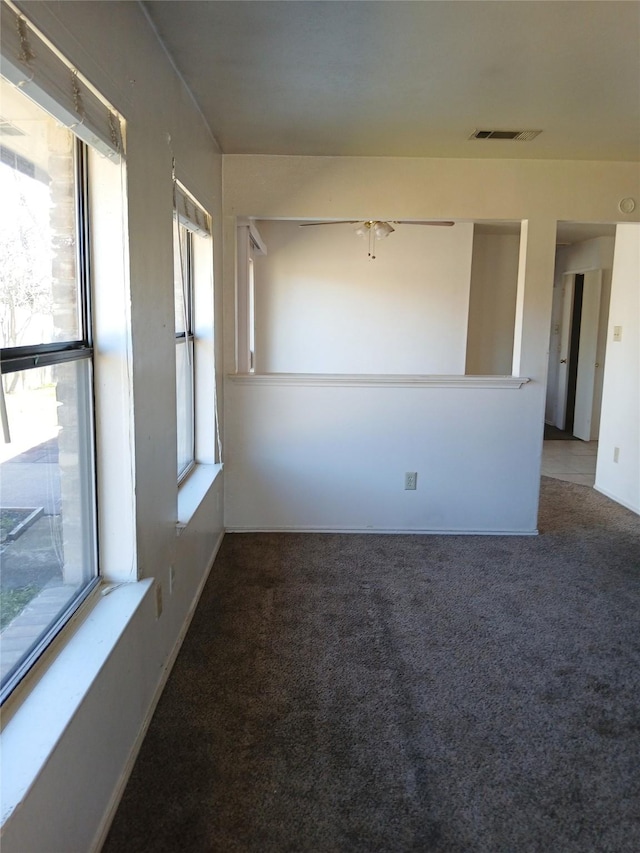 carpeted spare room with baseboards