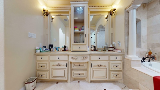 full bath featuring visible vents, a relaxing tiled tub, vanity, and decorative columns