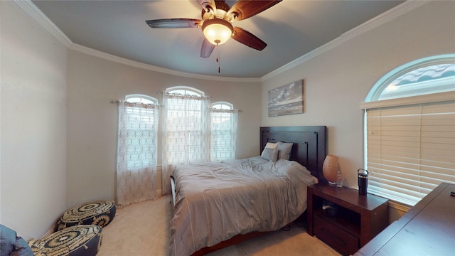 carpeted bedroom with ornamental molding and a ceiling fan