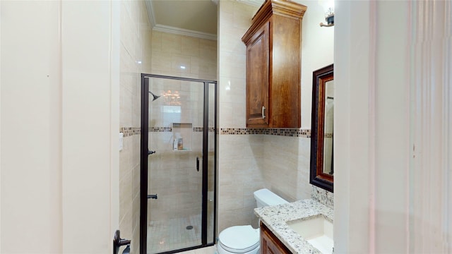 full bathroom with vanity, ornamental molding, toilet, a shower stall, and tile walls