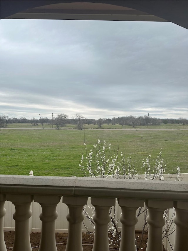 view of yard with a rural view and a balcony