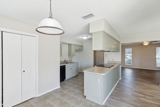 kitchen featuring gray cabinetry, visible vents, light countertops, black appliances, and decorative light fixtures