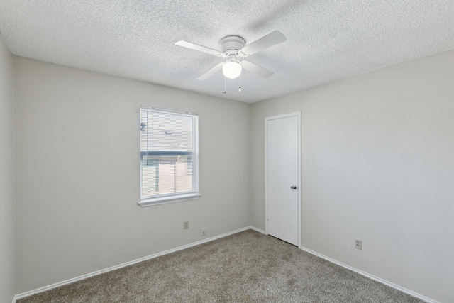 unfurnished room featuring ceiling fan, a textured ceiling, baseboards, and light colored carpet