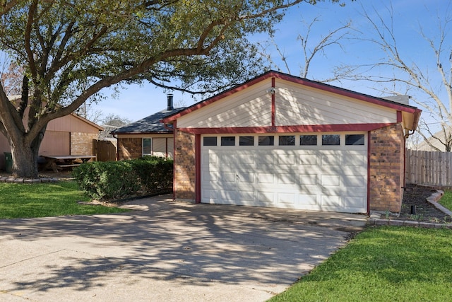 view of front of property with a garage, fence, an outdoor structure, and brick siding