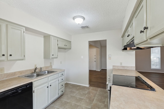 kitchen with a sink, visible vents, black dishwasher, electric stove, and light countertops