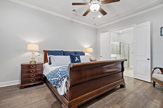 bedroom featuring connected bathroom, wood finished floors, visible vents, baseboards, and crown molding