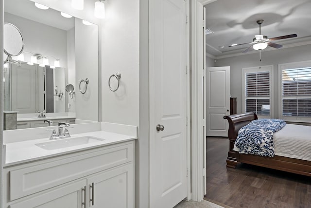 bathroom featuring ceiling fan, connected bathroom, wood finished floors, vanity, and crown molding