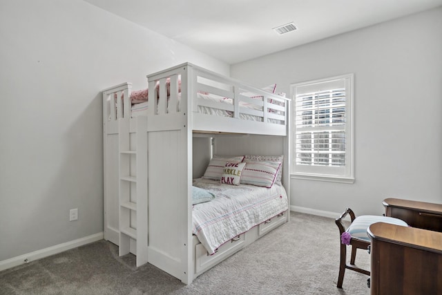 carpeted bedroom with baseboards and visible vents