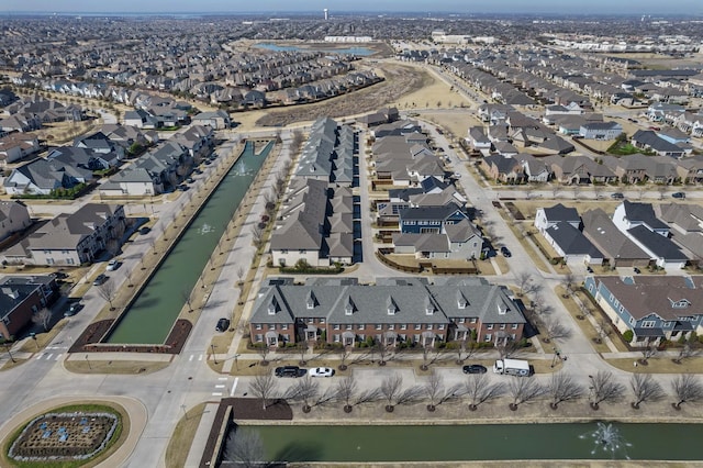 drone / aerial view featuring a residential view and a water view