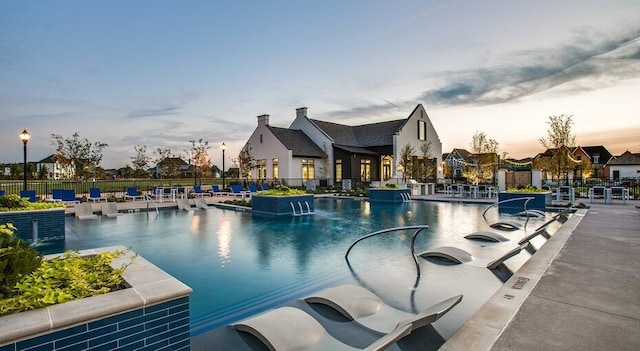 pool featuring a patio area and fence