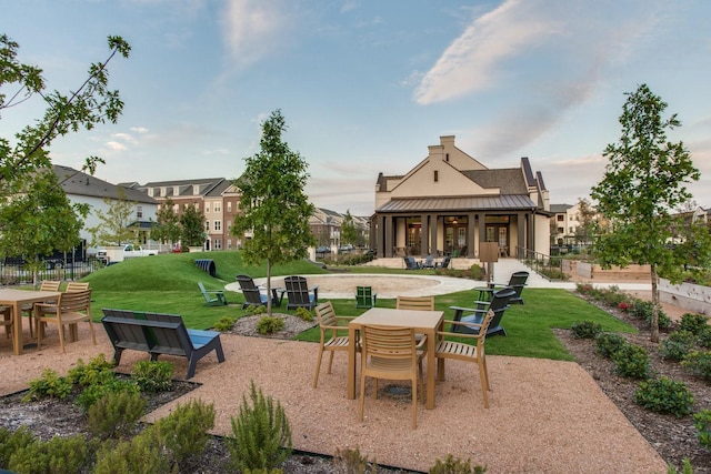 view of home's community with a patio area, a lawn, and fence