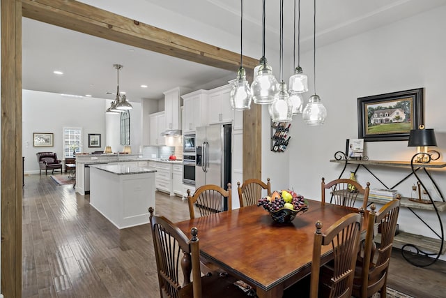 dining room with dark wood-style floors and recessed lighting