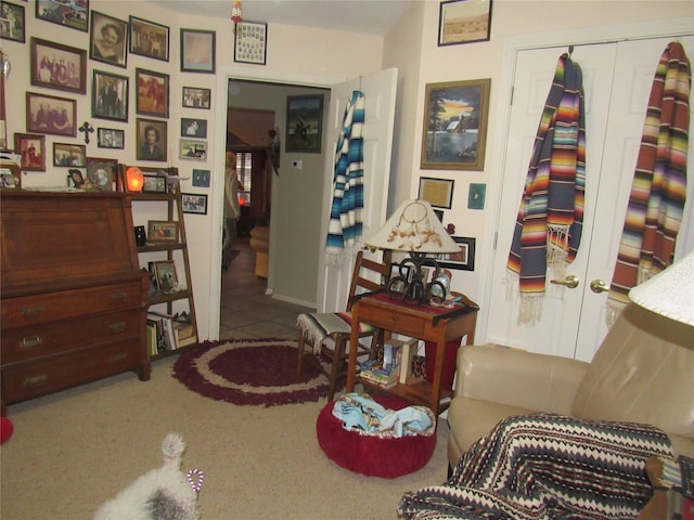 living area featuring carpet floors, french doors, and tile patterned floors