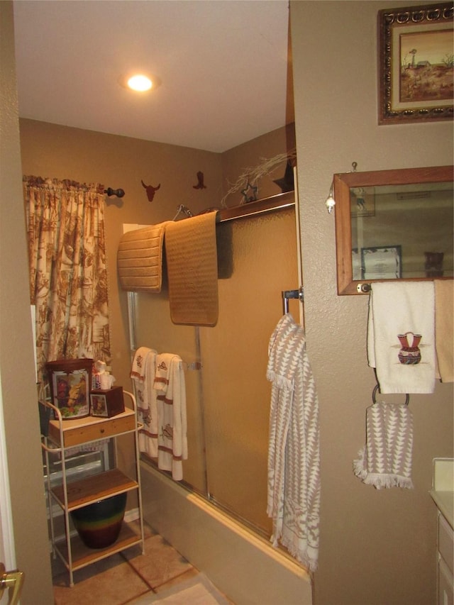 full bath featuring bath / shower combo with glass door, tile patterned flooring, vanity, and recessed lighting